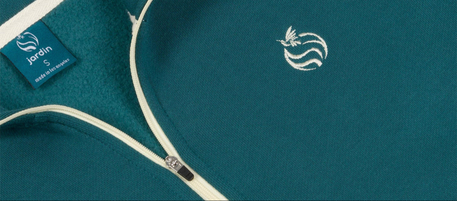 Detail of teal half zip with embroidery logo