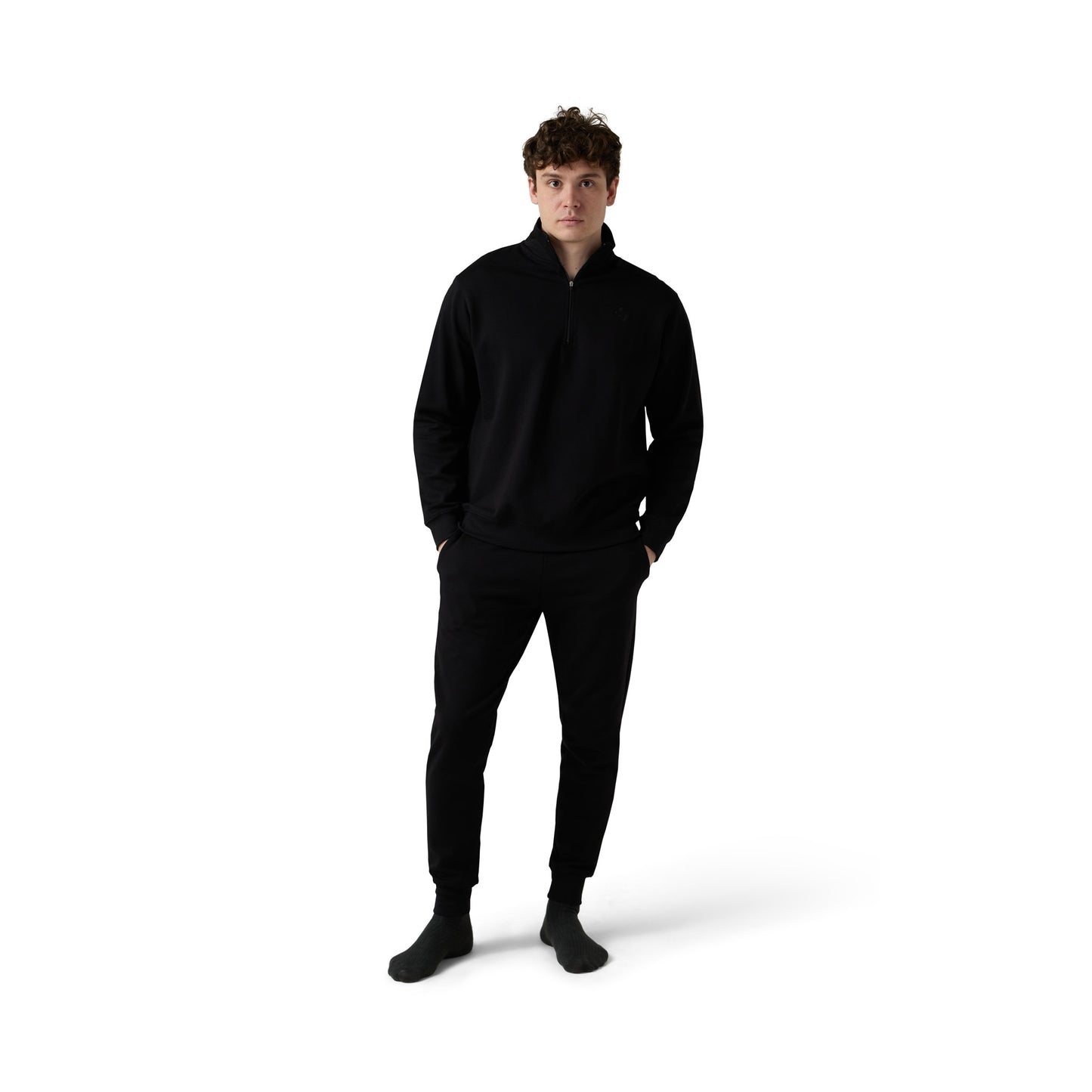 Male model wears black half zip set with joggers