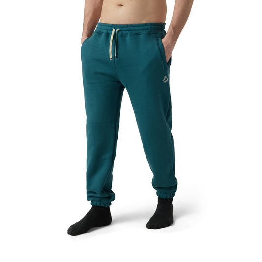 Male model wears teal sweatpants